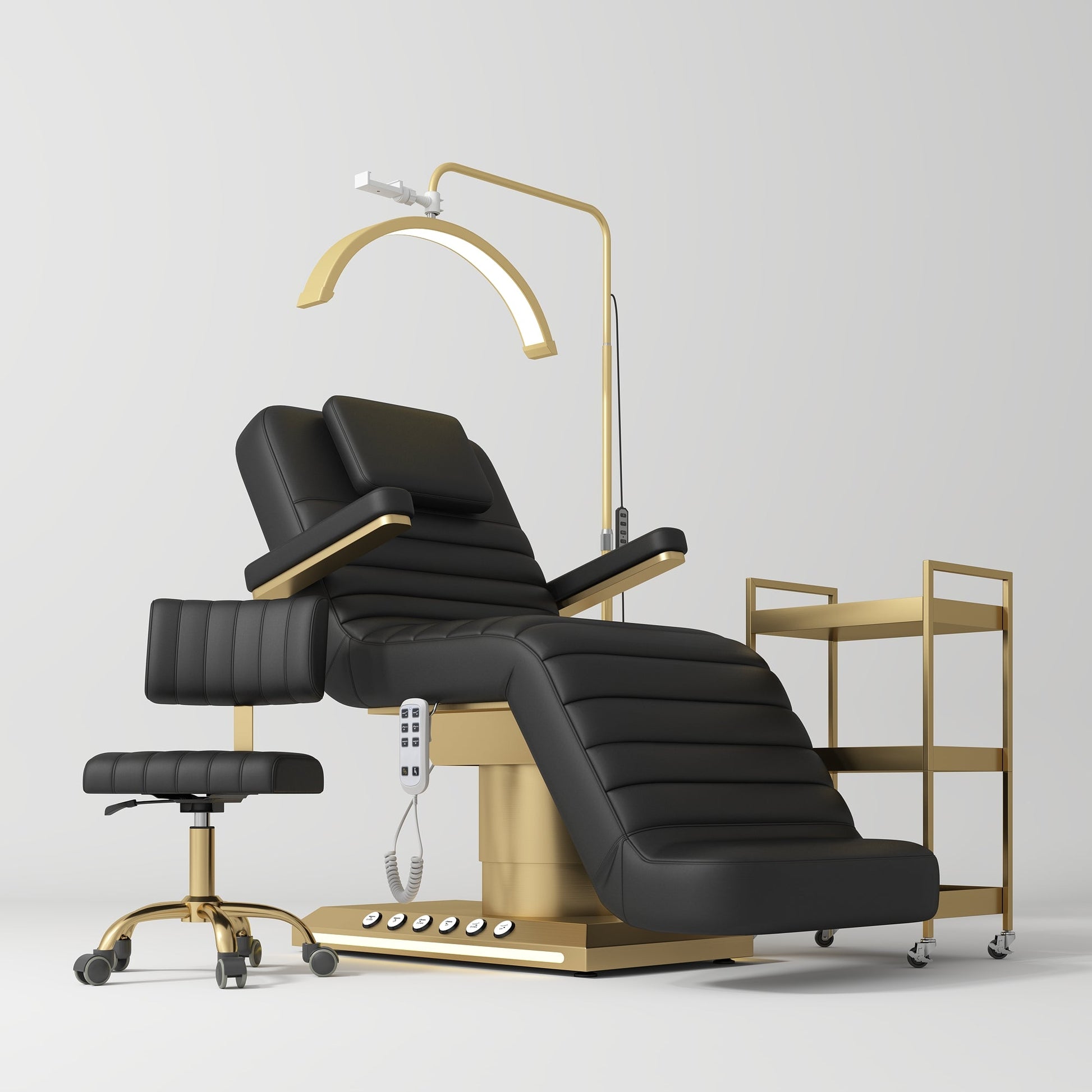 Black and gold reclining beauty chair with a lamp and side table on a white background